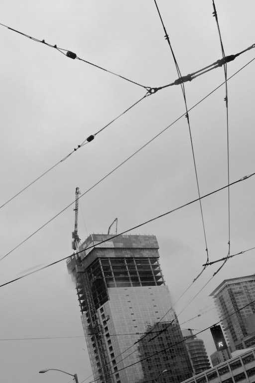 skyscraper construction and bus wires