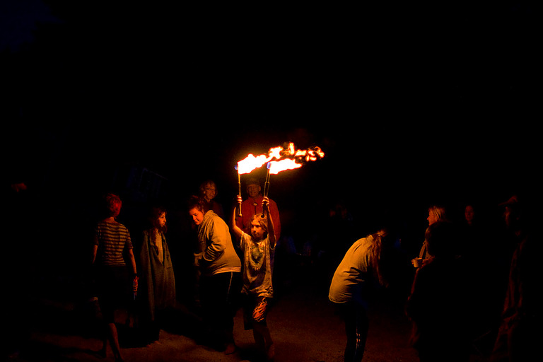 kid carrying torches