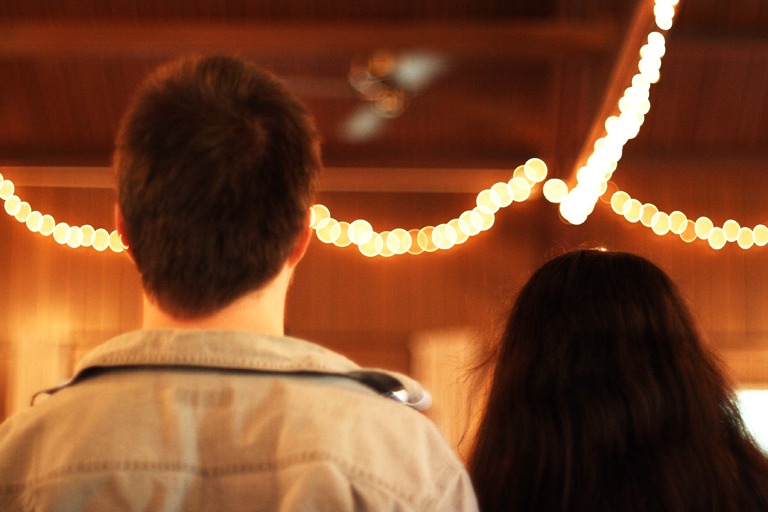 Zack and Marina from behind at their reception